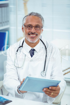 Doctor using digital tablet at clinic