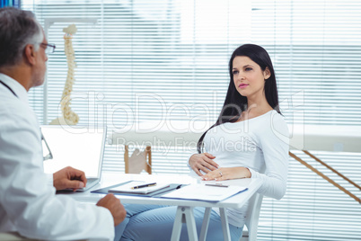 Pregnant woman interacting with doctor at clinic