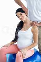 Doctor giving physiotherapy to pregnant woman