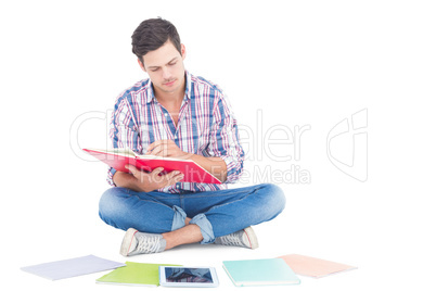 Man reading a book while sitting on the floor