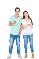 Smiling couple using their smartphones