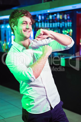 Happy man dancing in front of bar counter