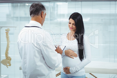 Pregnant woman interacting with doctor