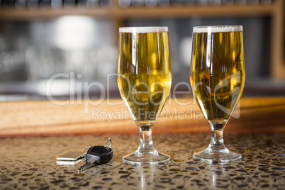 View of two pints of beer and car keys