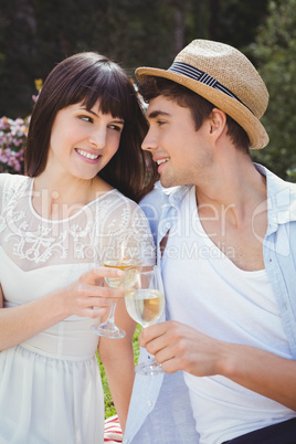 Young couple having glass of wine in garden