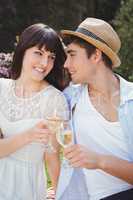 Young couple having glass of wine in garden