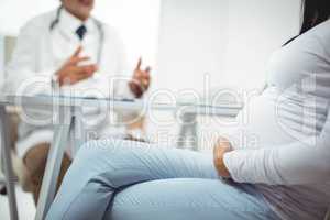 Pregnant woman sitting at clinic for health checkup