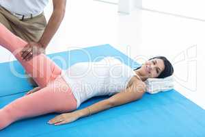 Doctor giving physiotherapy to pregnant woman