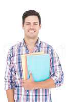 Portrait of smiling male college student holding books