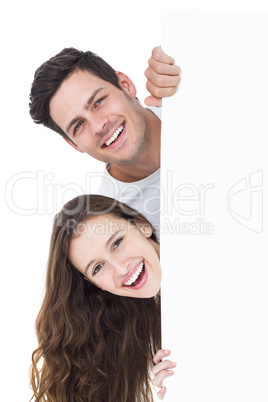 Happy couple looking over a poster