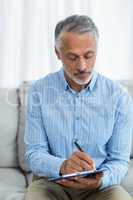 Doctor sitting with a clipboard