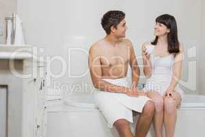 Young couple sitting on the bathtub