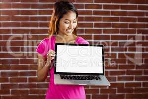 Smiling asian woman holding computer