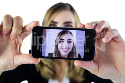 Smiling woman taking selfie