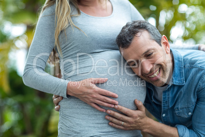 Man listening to pregnant womans stomach