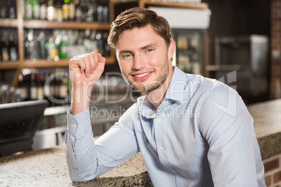 Handsome man leaning his elbow on the counter