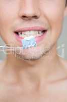 Close-up of man brushing teeth