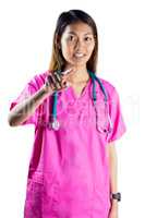 Asian nurse with stethoscope pointing in front of her