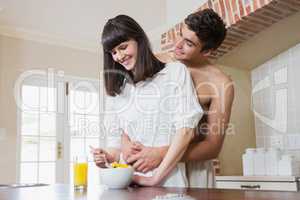 Young couple embracing while having breakfast