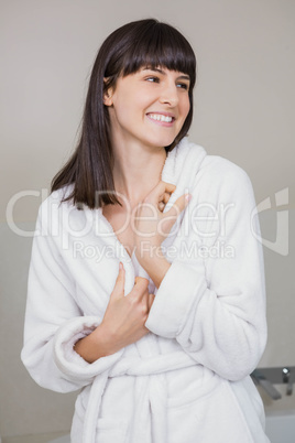 Beautiful young woman in white bathrobe