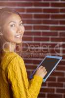 Smiling asian woman using tablet