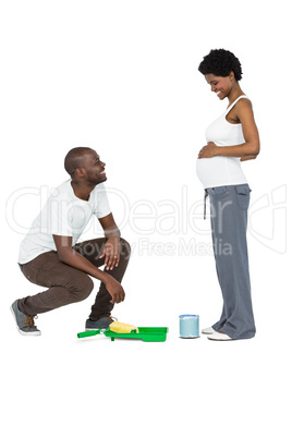 Pregnant couple with paint tin