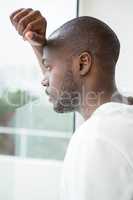 Thoughtful man looking out of window