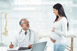 Pregnant woman interacting with doctor at clinic