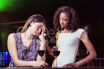 Woman having drinks and comforting her depressed friend