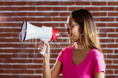 Asian woman shouting in megaphone