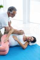 Doctor giving physiotherapy to pregnant woman