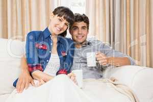 Portrait of couple at home relaxing on the sofa