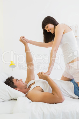 Young couple having fun on bed