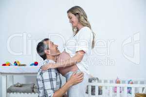 Man touching the belly of pregnant woman