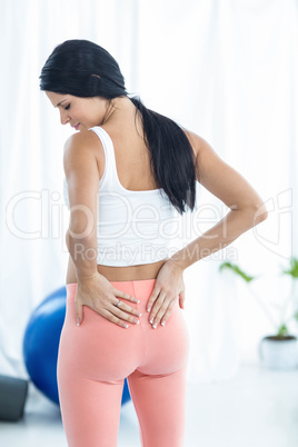 Pregnant woman looking down while exercise