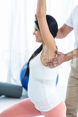 Doctor giving physiotherapy to pregnant woman