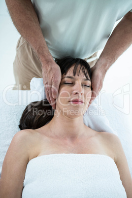 Pregnant woman receiving a massage from masseur