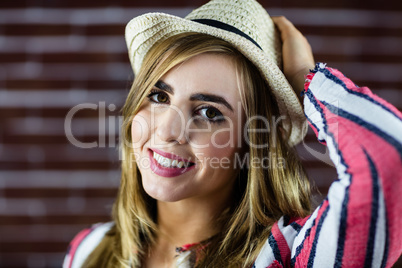 Smiling woman touching her hat