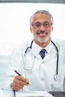Doctor writing on notepad