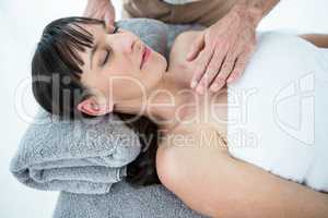 Pregnant woman receiving a massage from masseur
