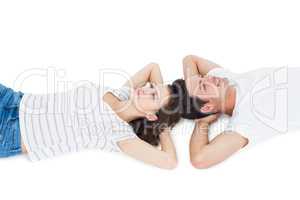 Happy couple lying on the floor head to head
