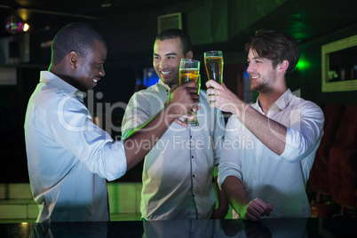 Group of men toasting with glass of beer