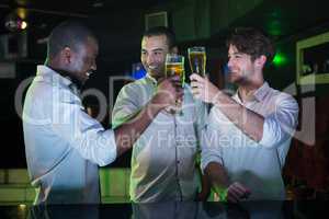 Group of men toasting with glass of beer