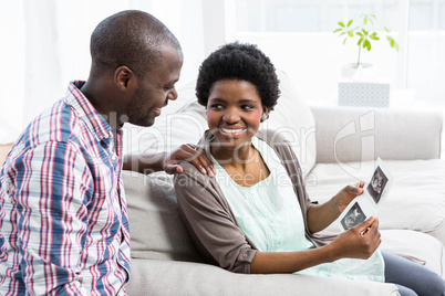 Pregnant couple looking at ultrasound scan Pregnant couple looking at ultrasound scan
