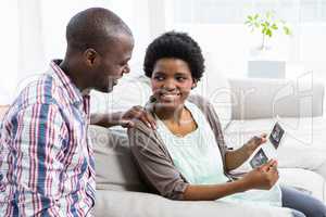 Pregnant couple looking at ultrasound scan