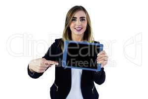 Smiling woman pointing on tablet