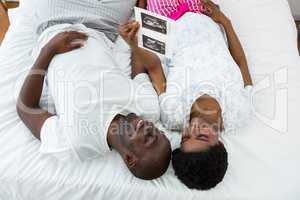 Pregnant couple looking at ultrasound scan