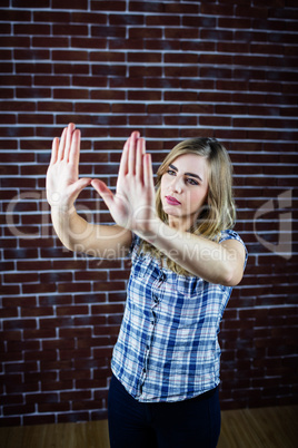 Pretty blonde woman looking through her hands