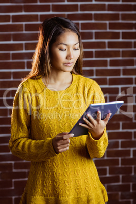 Focused asian woman using tablet