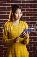 Focused asian woman using tablet